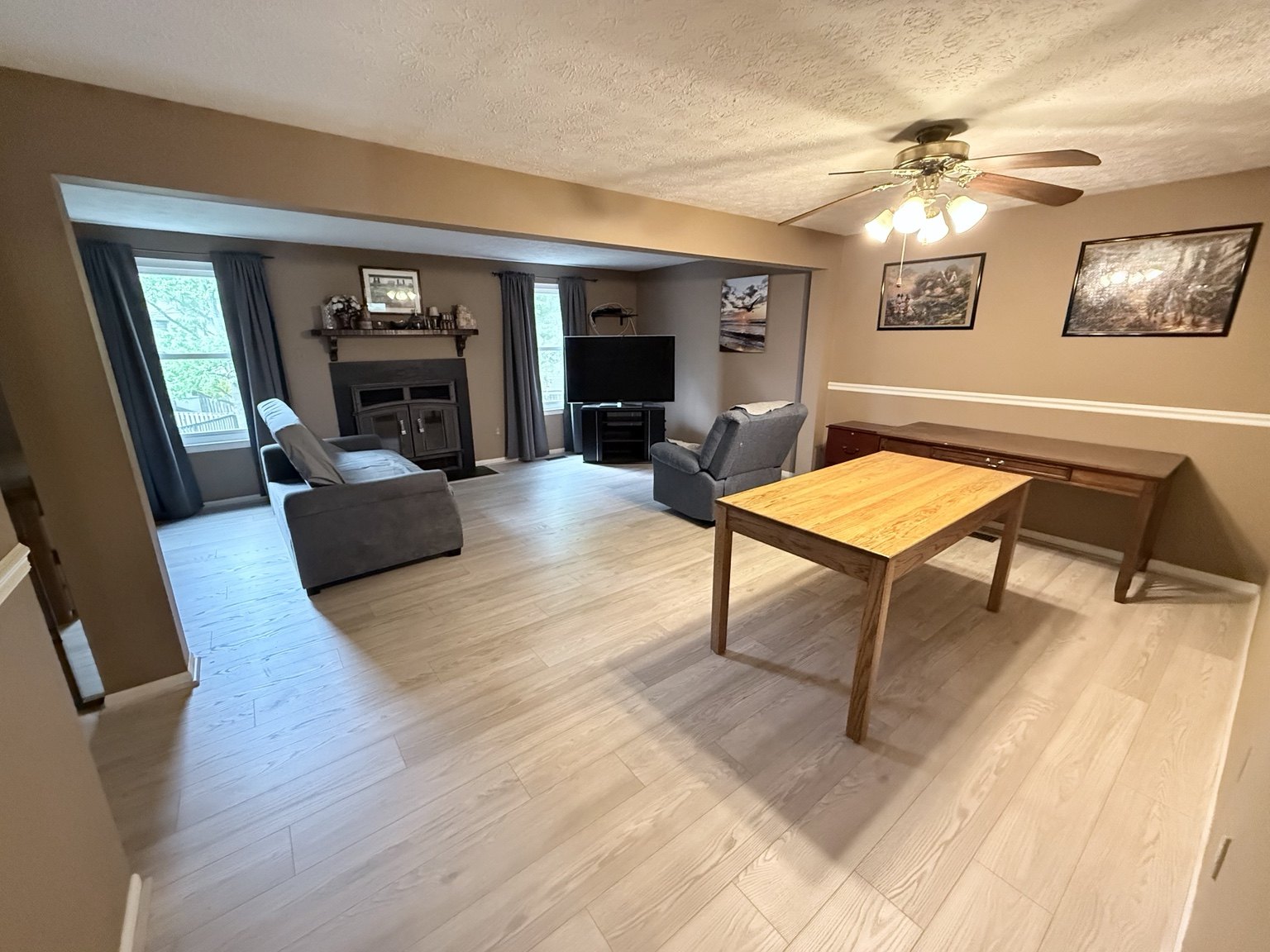 Bright living area with light plank flooring