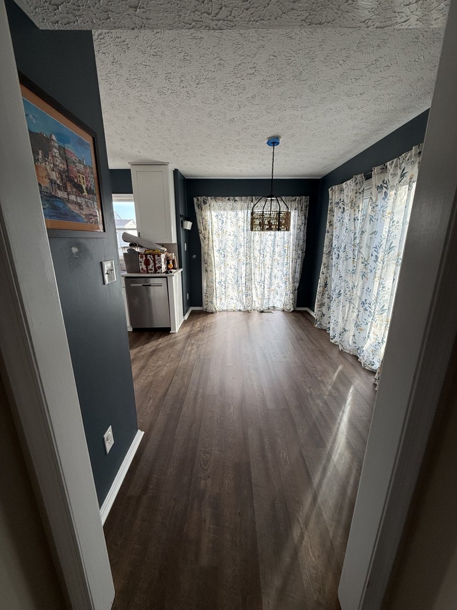 Kitchen and dining area with dark flooring