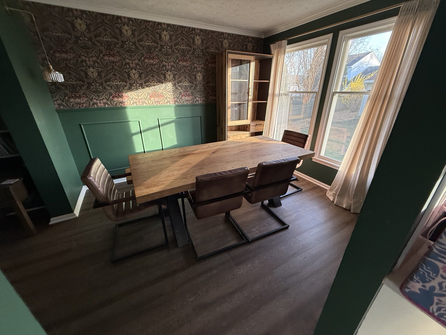 Dining room with dark wood-look flooring